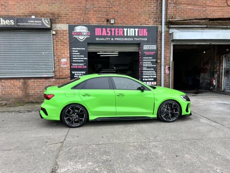 Green Audi RS3 saloon with tinted windows outside the Mastertint UK workshop, Bolton