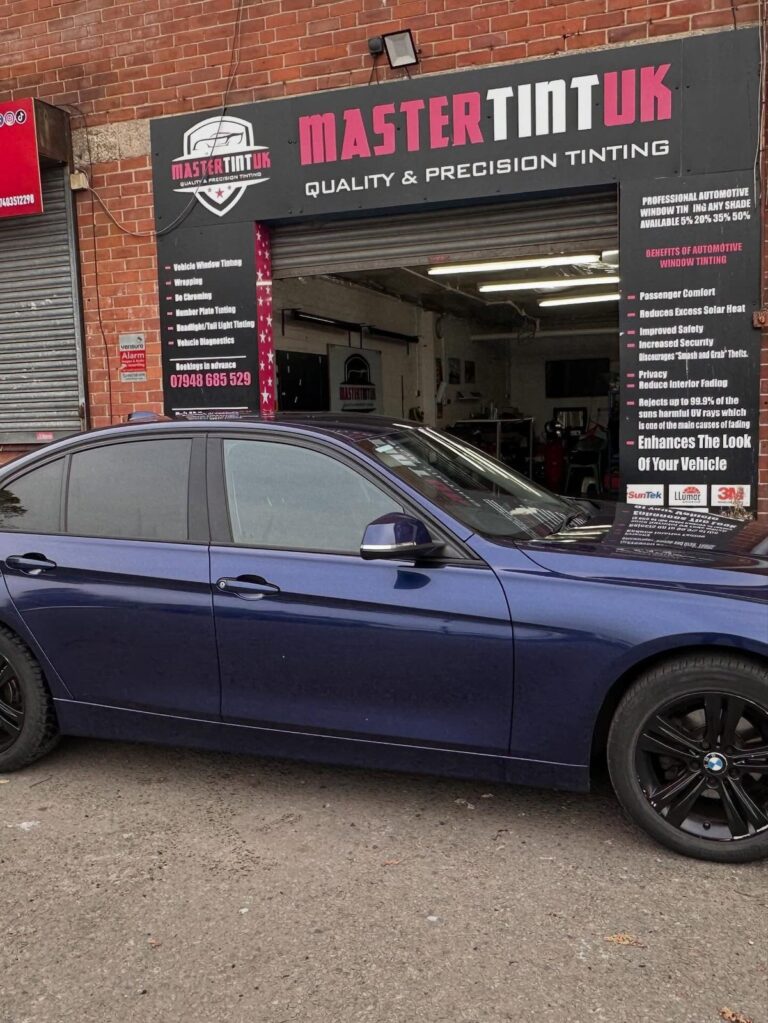 Blue BMW 3 Series with tinted windows outside the Mastertint UK workshop, Bolton
