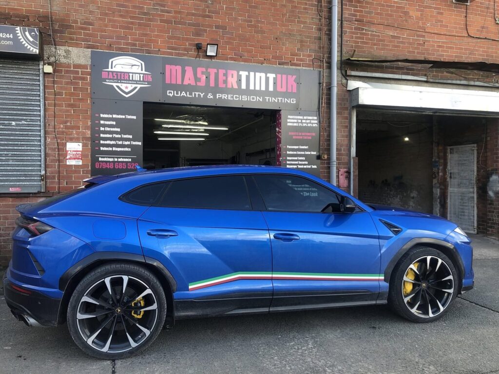 Blue Lamborghini Urus with tinted windows outside the Mastertint UK workshop, Bolton