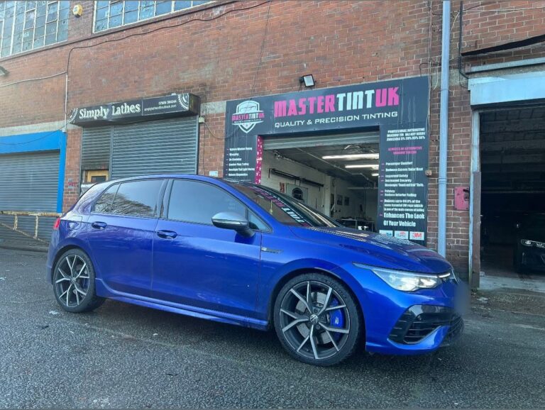 Blue VW Golf R with tinted windows parked outside the Mastertint UK window tinting workshop, Bolton